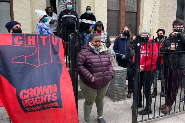 Tenants, including Ayanna Dore, center, rally outside their building at 567 Saint John’s Pl. Sunday afternoon.